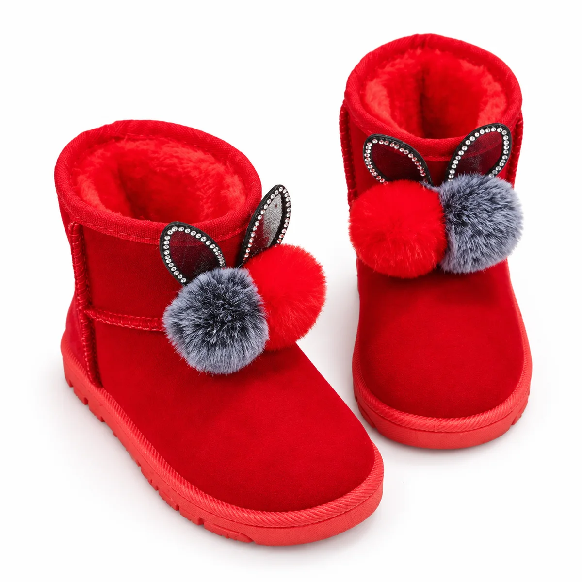 bottines fille rouges fourrees lapin a pompons sur fond blanc