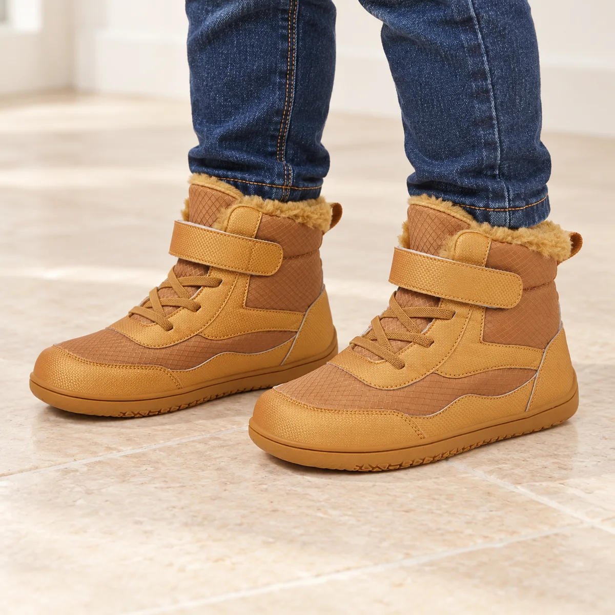 bottines garcon marron fourrees a bout large portees par un enfant