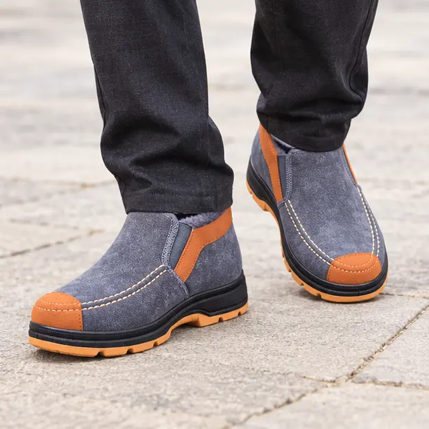 bottines homme grises fourrees style mocassin portees en marchant avec un pantalon sombre 45462