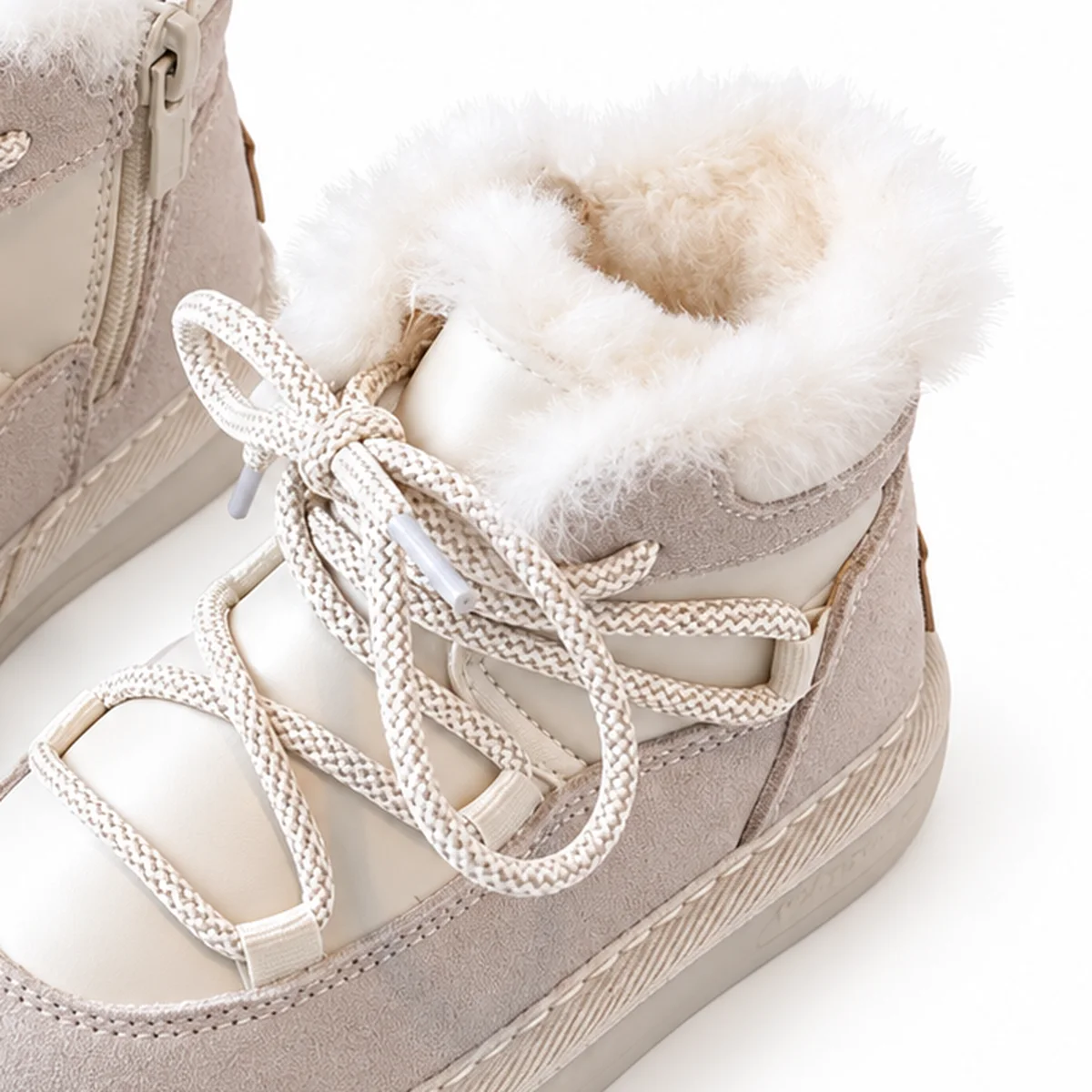 gros plan du haut des bottines enfant beiges fourrees a lacets et zip