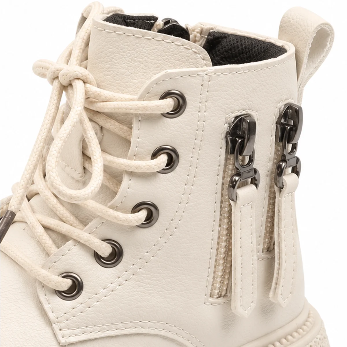 gros plan du haut des bottines garcon beiges non fourrees a lacets et zips