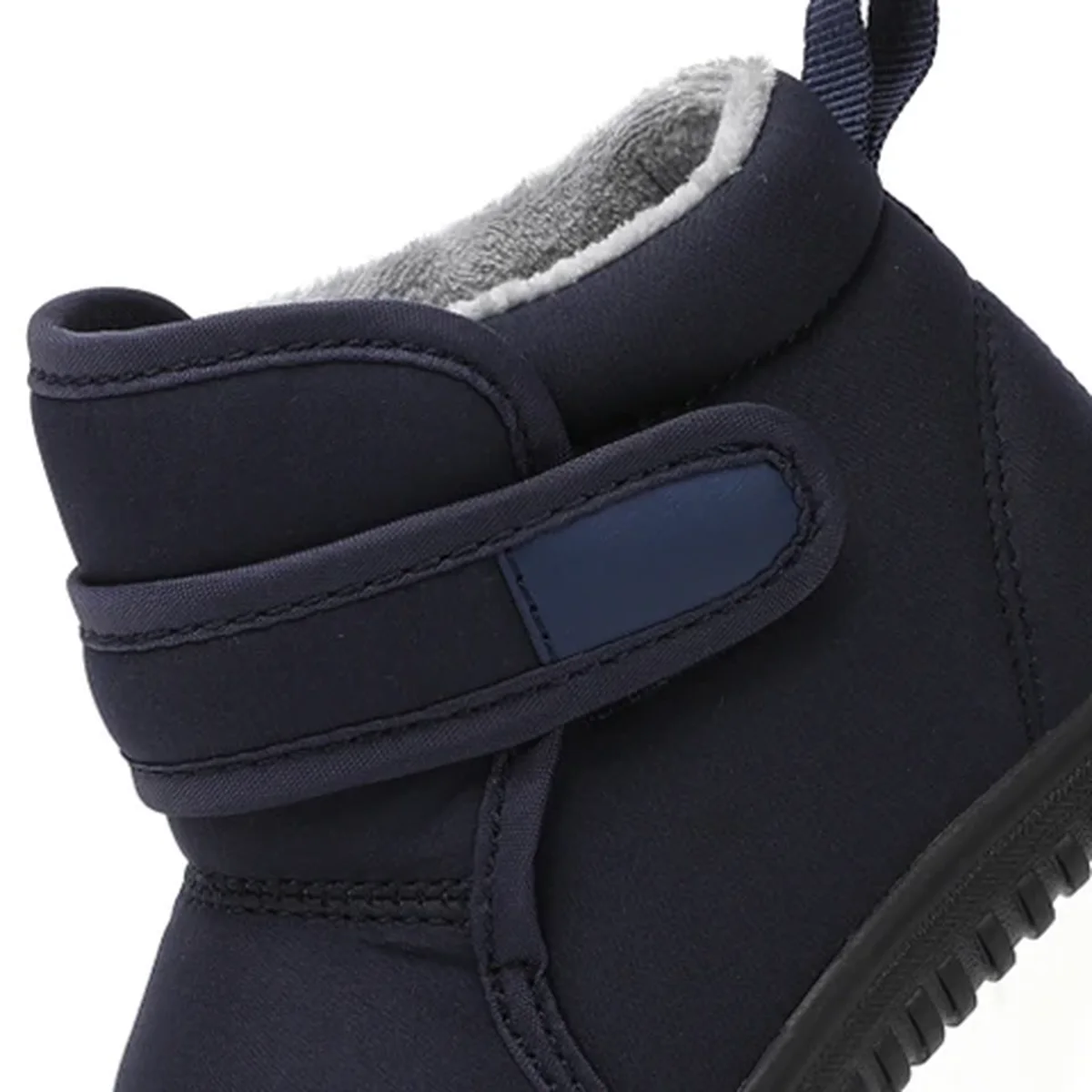 gros plan du haut des bottines garcon bleu marine fourrees a scratch