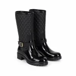 Bottes de pluie noires à matelassage et bas verni présentées sur fond blanc.