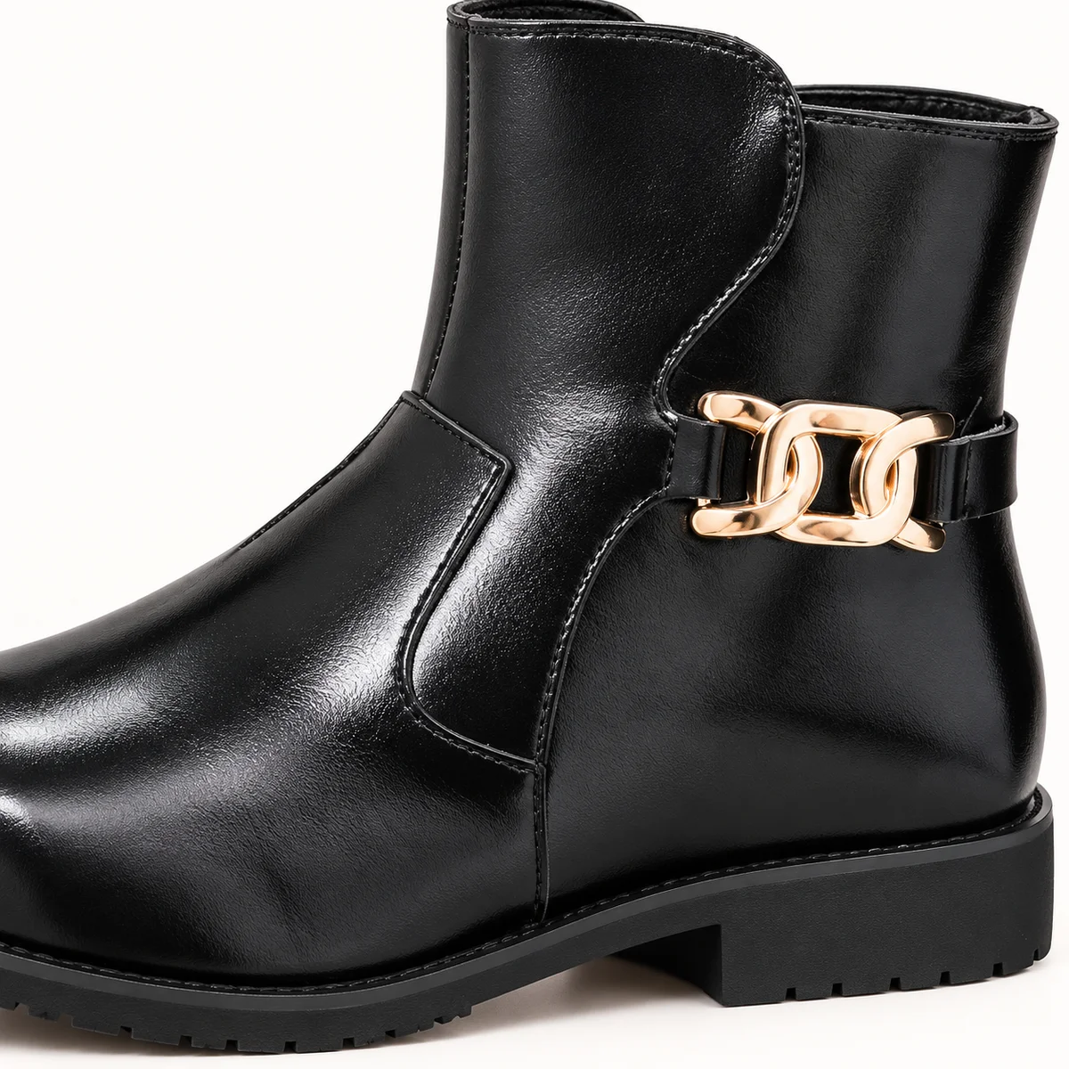 Vue de devant des bottines homme noires brillantes à bride or pour mode masculine